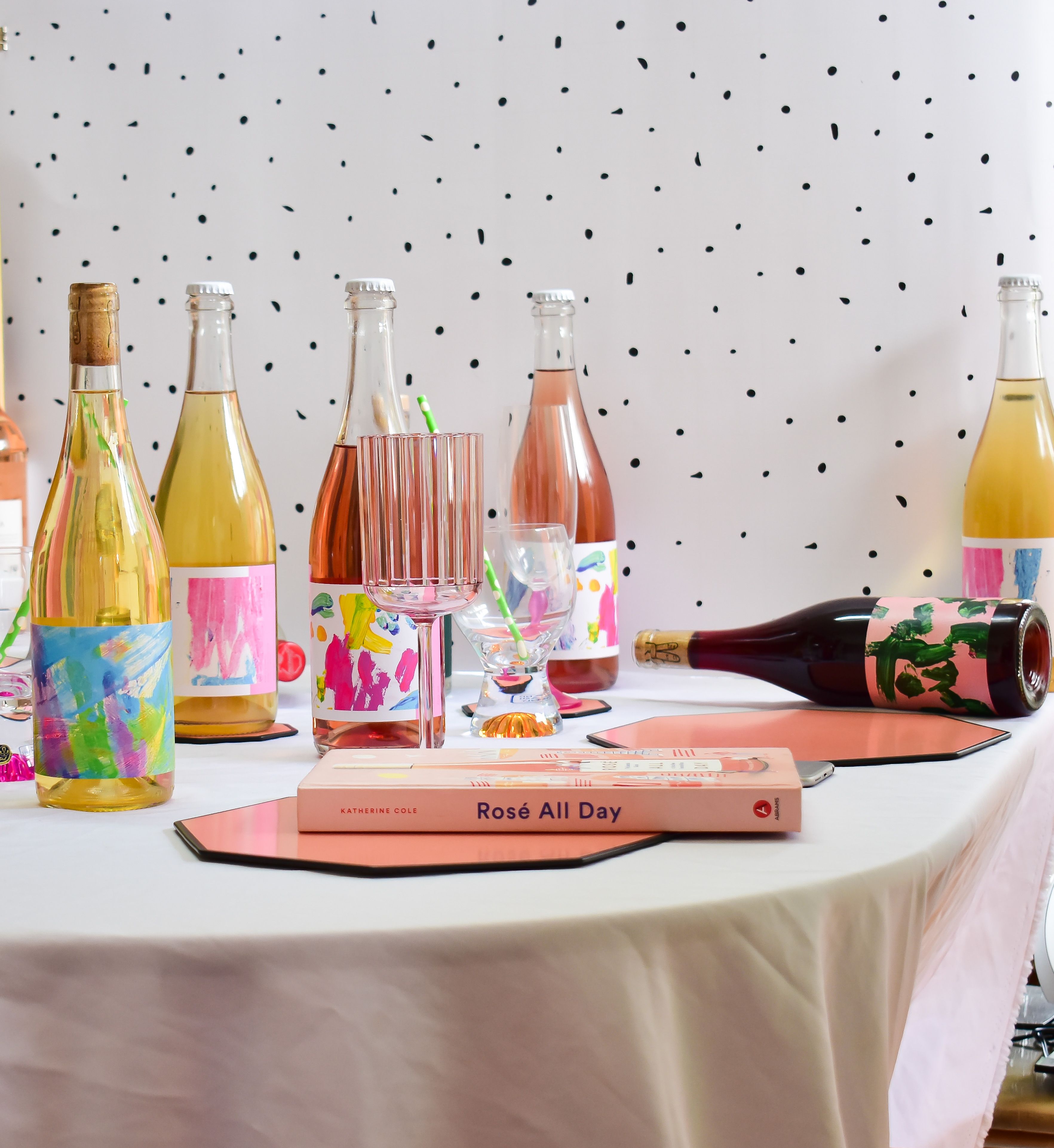 Vibrant party table with wine bottles and the book 'Rosé All Day' in Melbourne.
