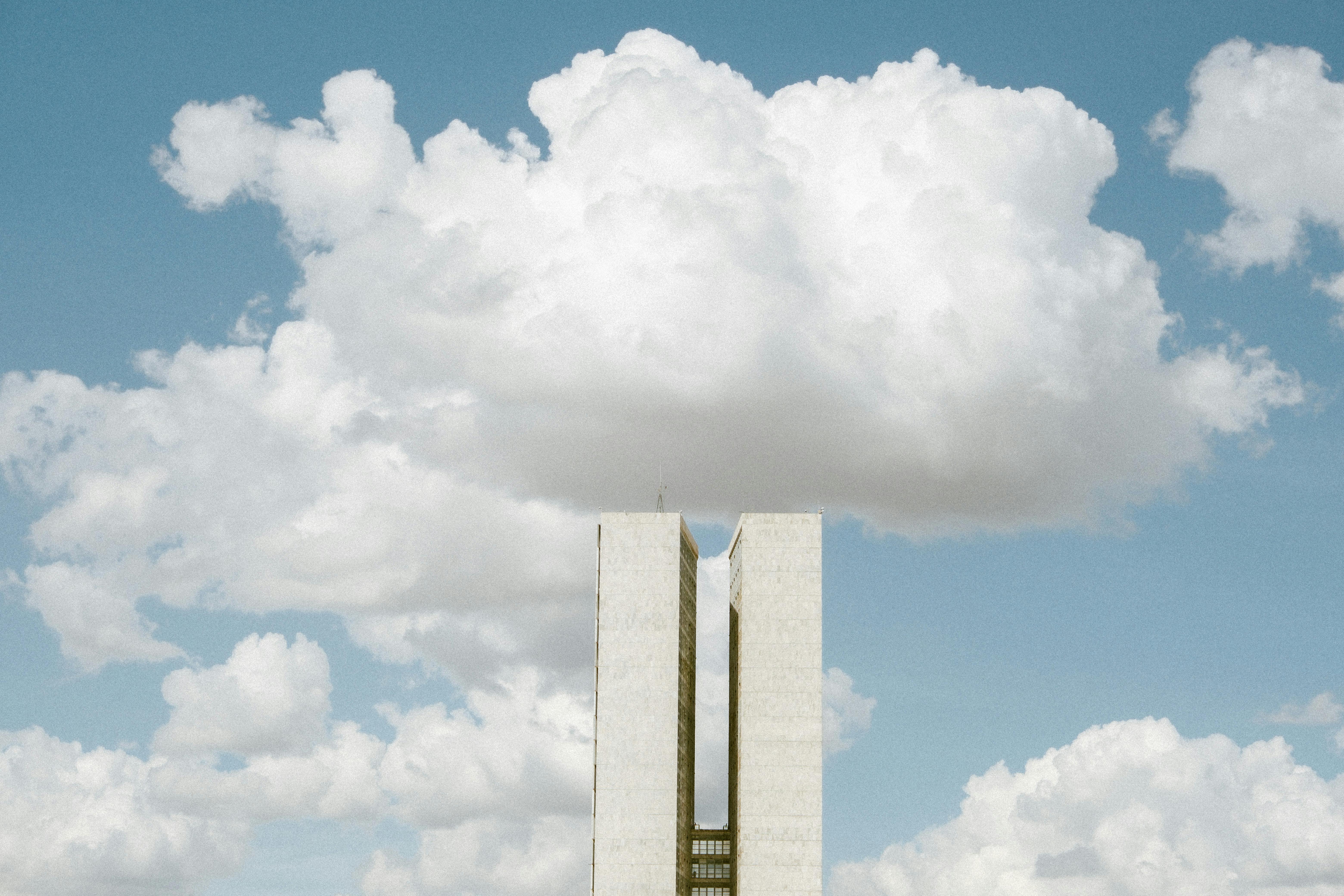 View of the National Congress in Brasília with impressive cloud formations in the sky.
