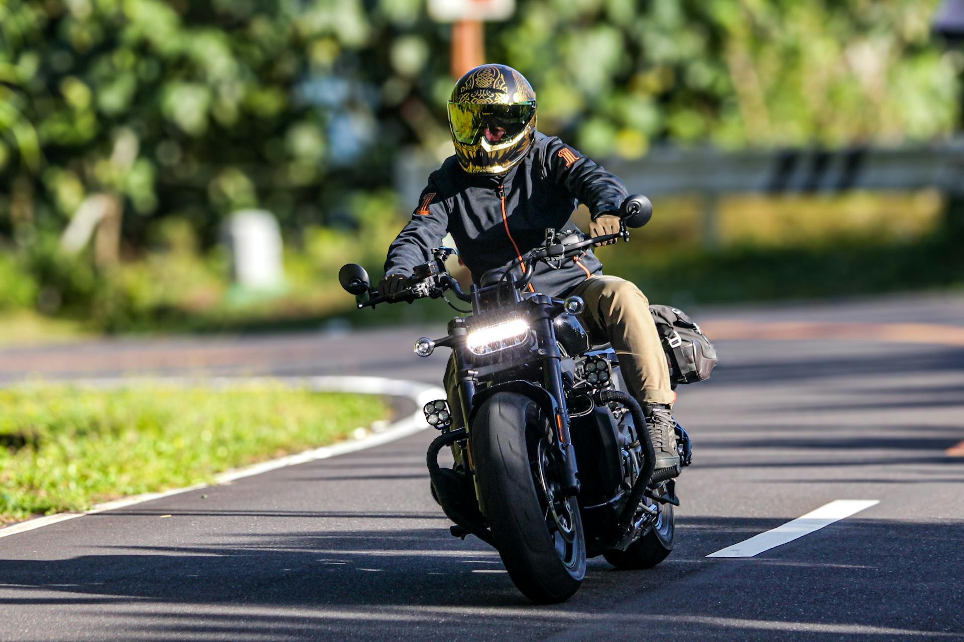 A motorcyclist in a helmet rides on a scenic road in Bicol, Philippines, capturing speed and freedom.