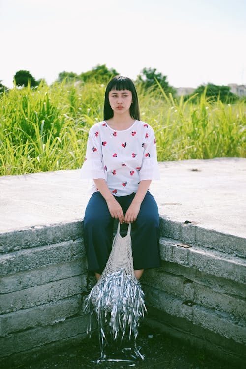 Woman Sitting Holding A Net With Fish