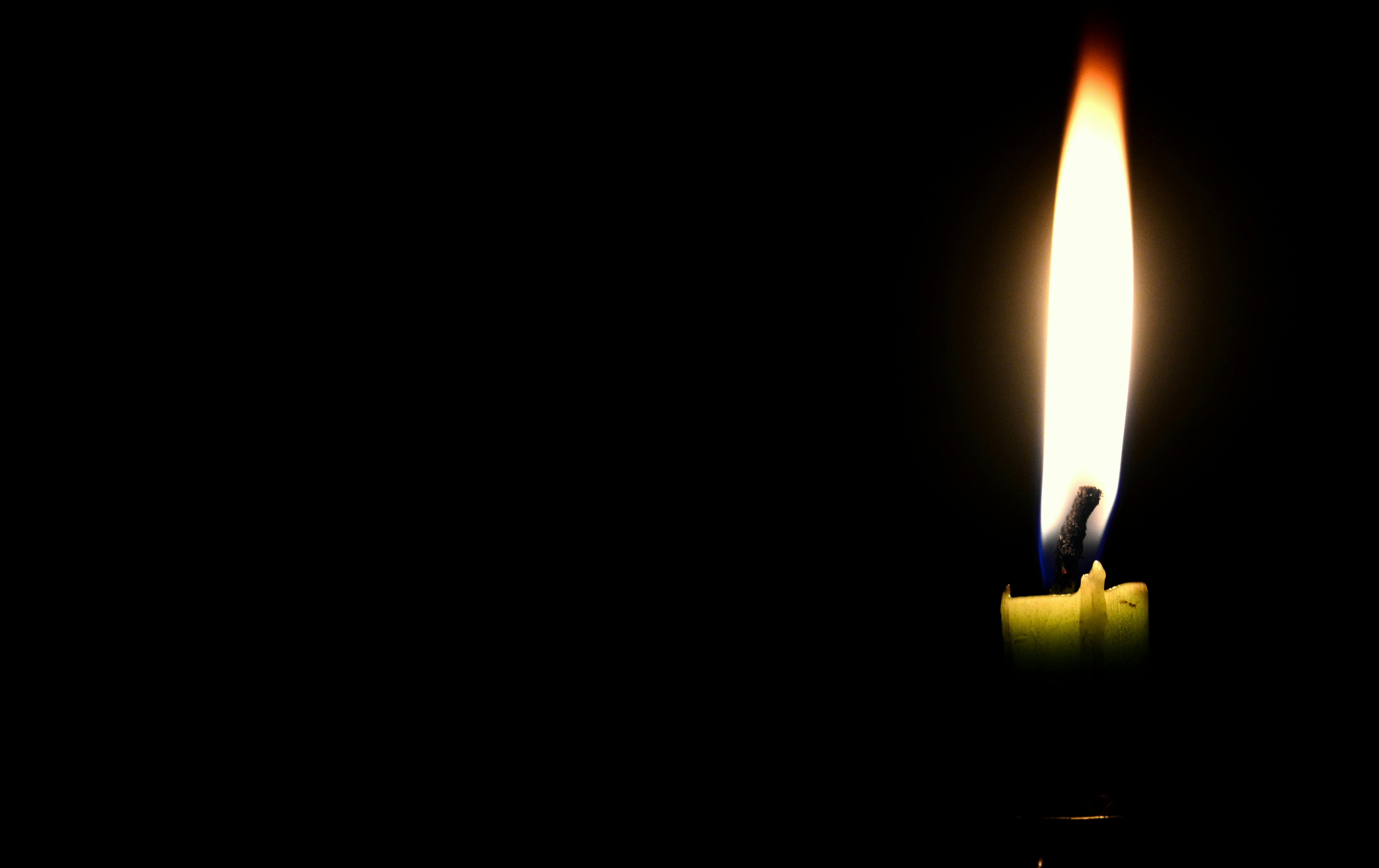 Close-up of Illuminated Candle Against Black Background · Free Stock Photo