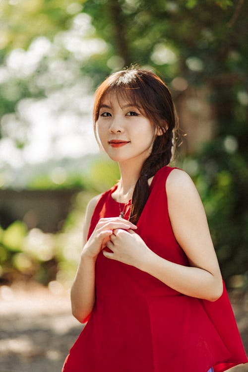 A woman in red is posing for a photo