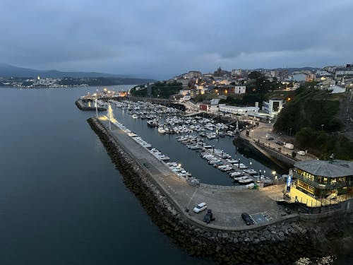 View of the Ribadeo harbor with a lot of boats in it and Ribadeo city in the background, Galicia, Spain, May 2023