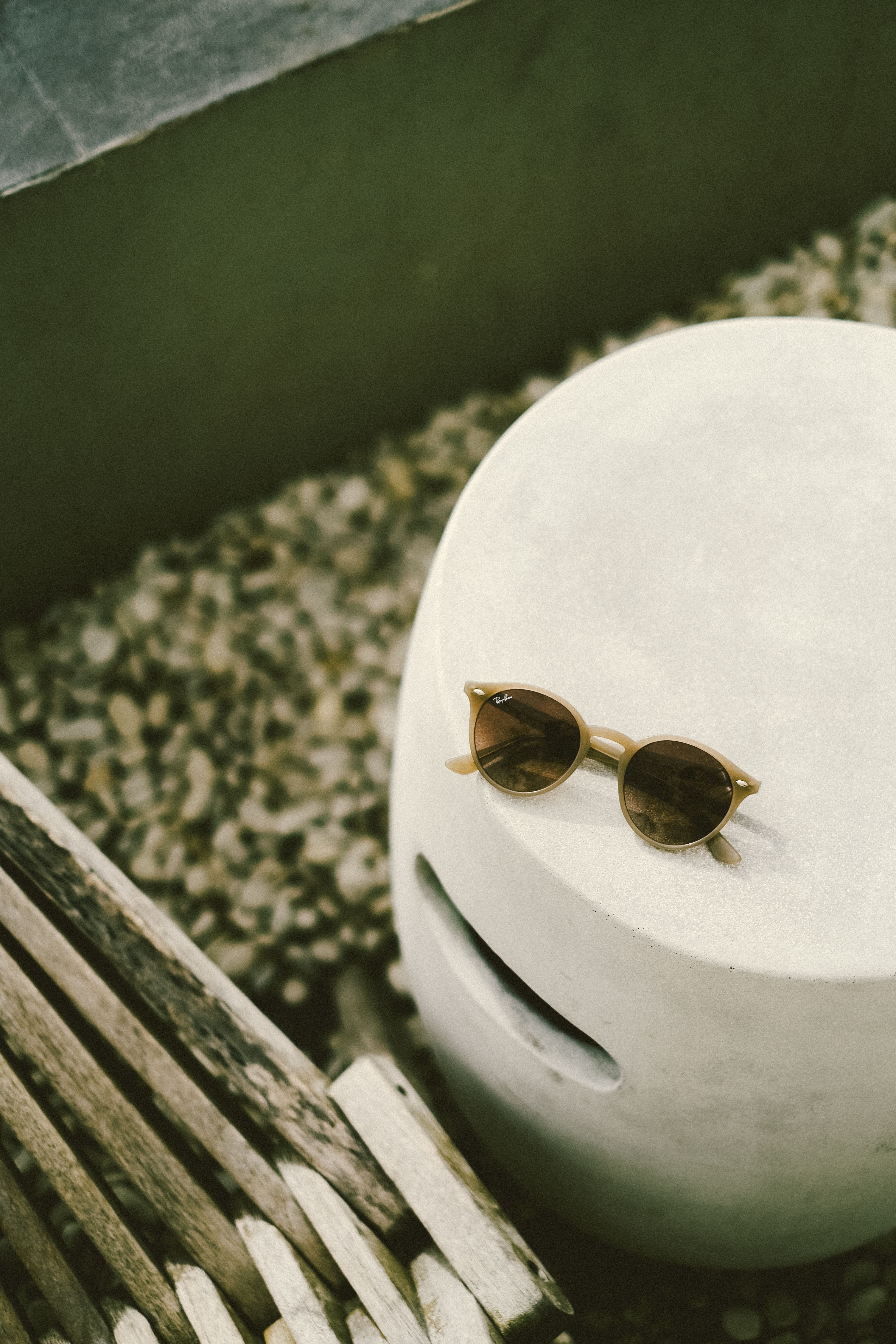 A pair of sunglasses sitting on top of a white object · Free Stock Photo