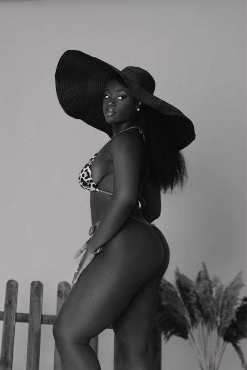 A black and white photo of a woman in a hat