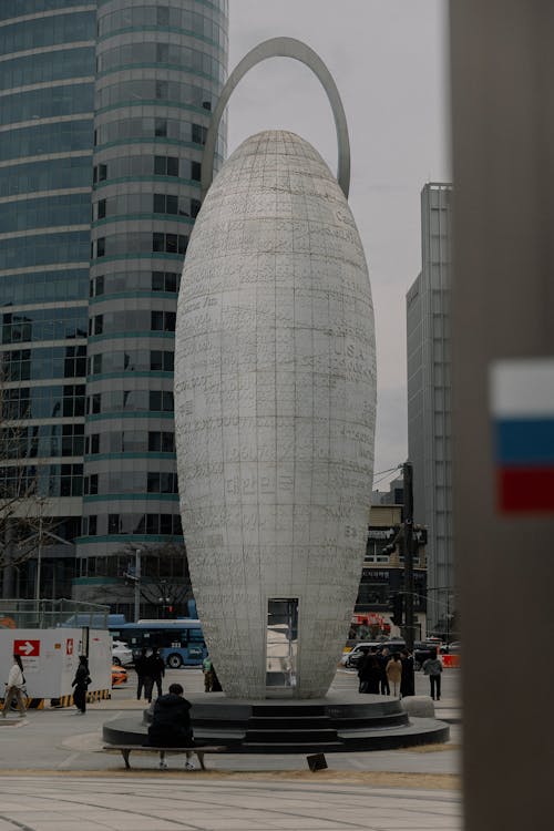 A large white sculpture in the middle of a city