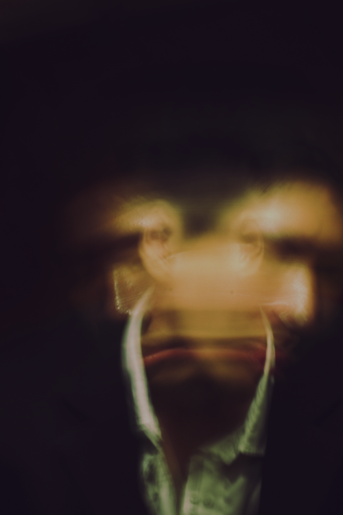 Free An artistic portrait capturing a man's blurred face, creating a surreal effect. Stock Photo