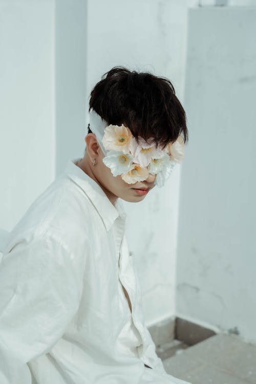 A man with a flower headband on his face