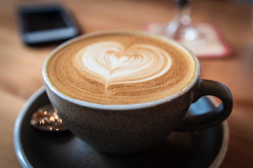 Free Selective Focus Close-up Photo of Cappuccino in Gray Ceramic Mug With Saucer Stock Photo