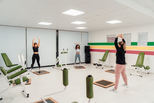 Three women engage in a workout session in a brightly lit, modern fitness studio in Yalova, Türkiye.