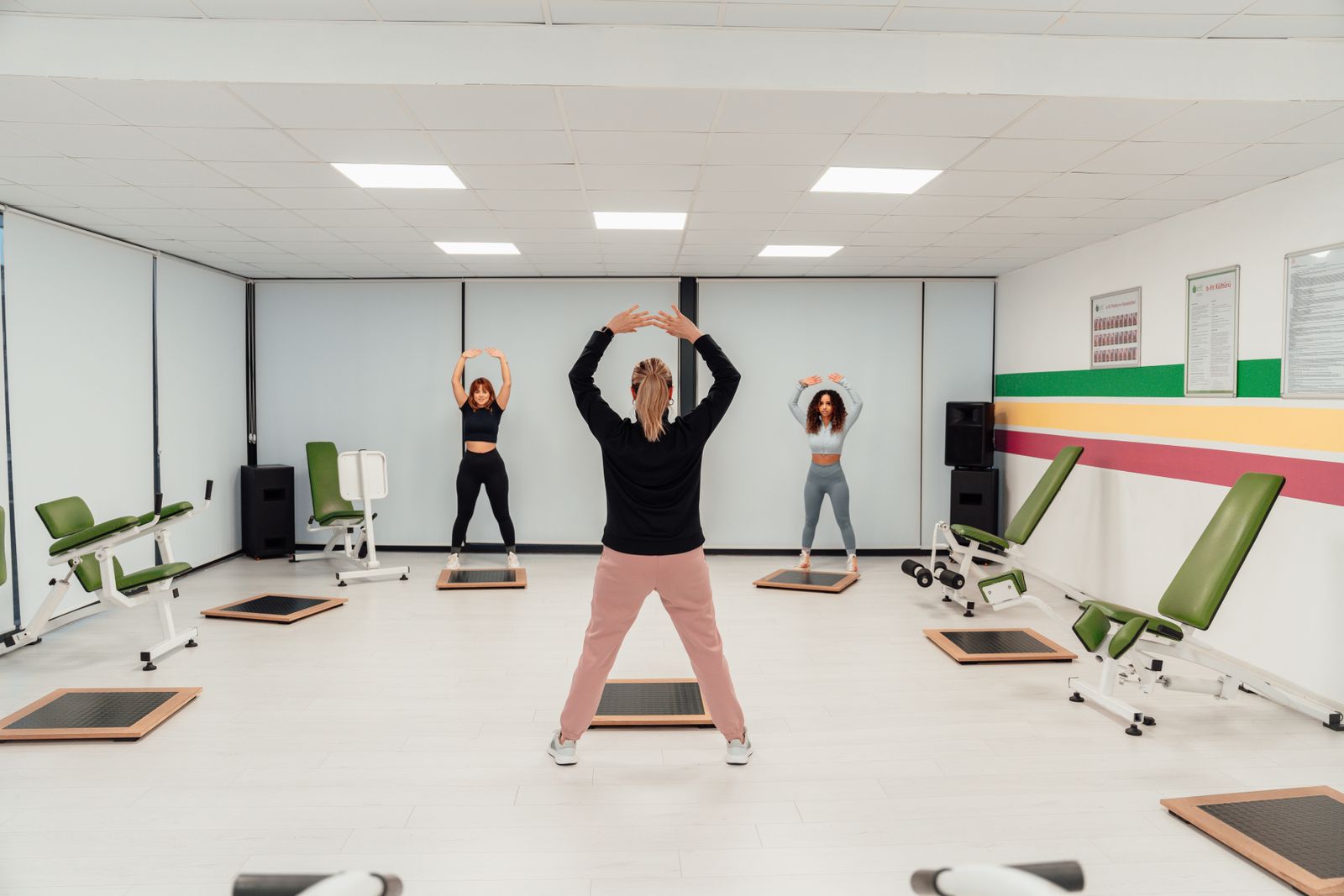 Woman following an online fitness class from home on a laptop