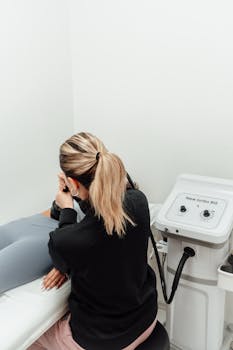 Back view of a woman conducting a medical examination in a clinic.
