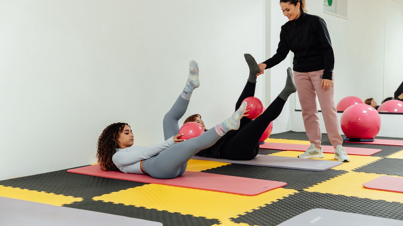 Instructor guiding women during a yoga class