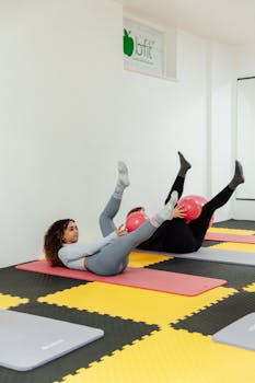 Women working out with exercise balls on gym mats in a fitness studio, Yalova, Türkiye.