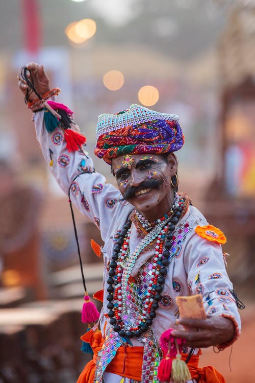 Free Man Wearing Make Up and Colored Dress While Dancing  Stock Photo