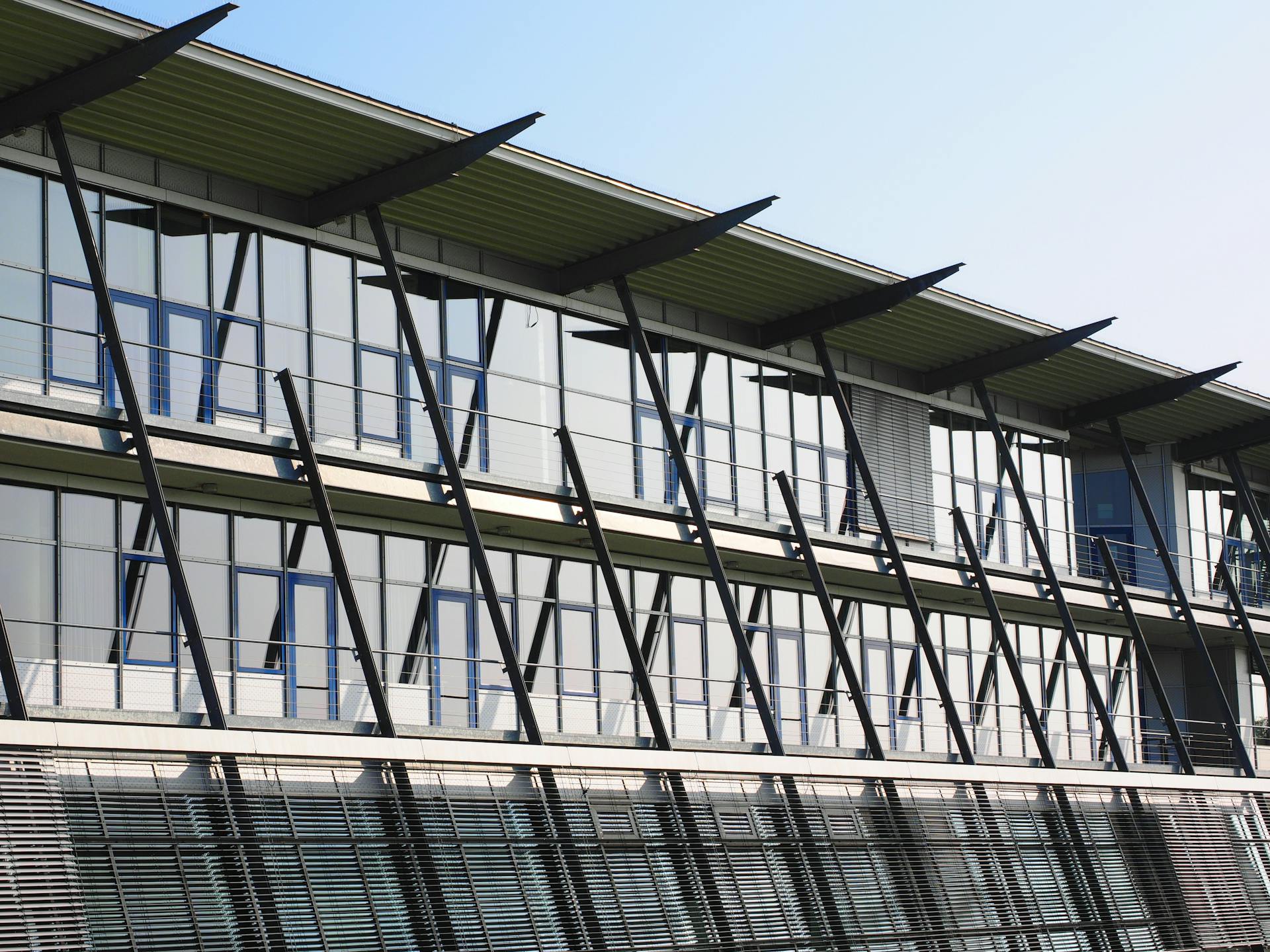 Contemporary office building featuring glass facade and unique architectural design, reflecting modern industry innovation.