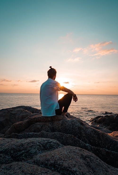 Man Sitting On A Rock