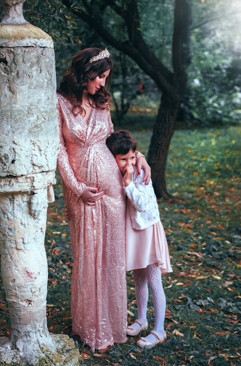 Woman In  Pink Long-sleeved Dress With Child