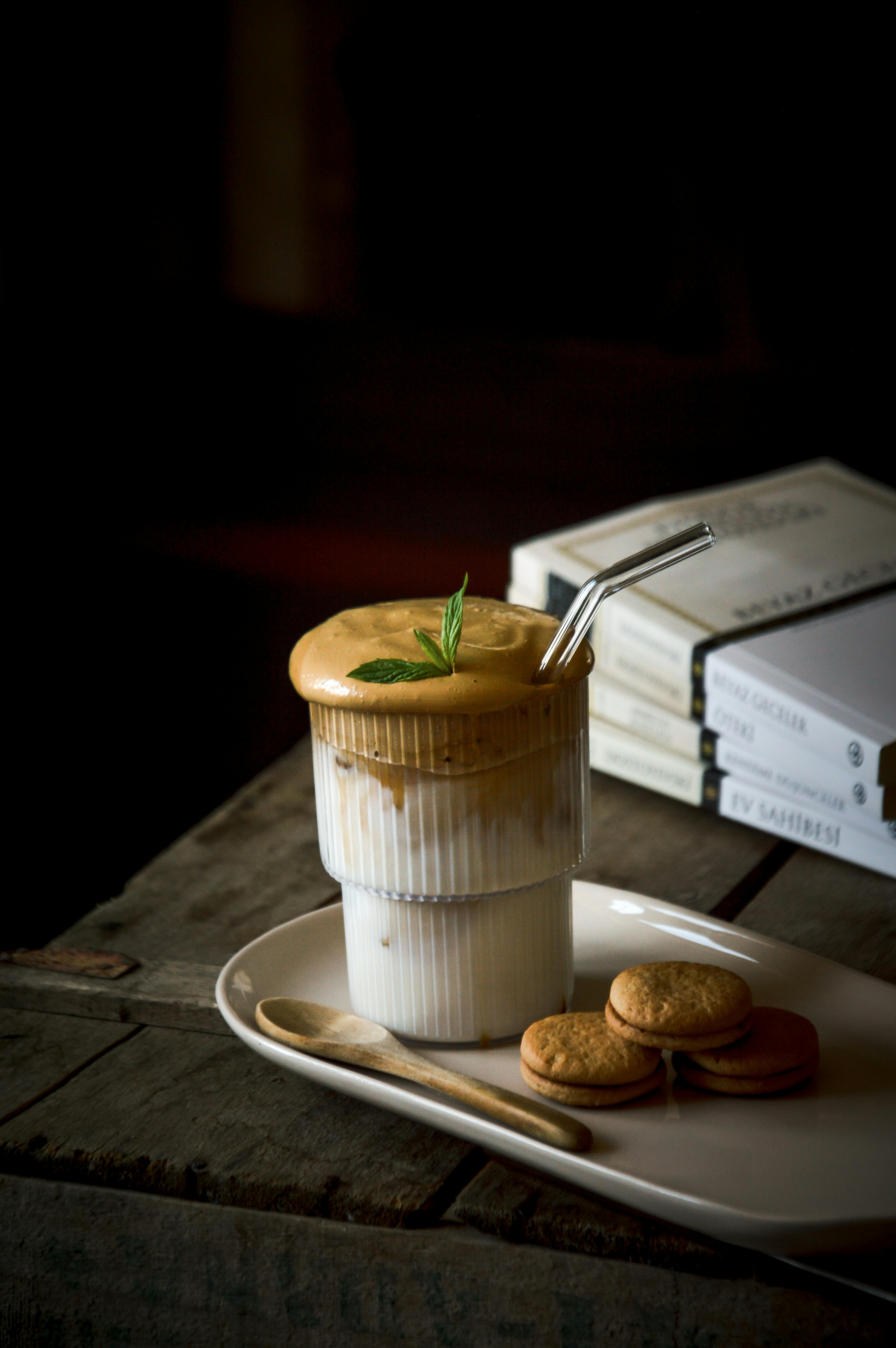 Elegant coffee in a glass with biscuits against a dark background. Perfect for food and drink concepts.