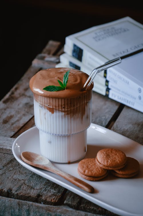 A cup of chocolate with cookies and mint