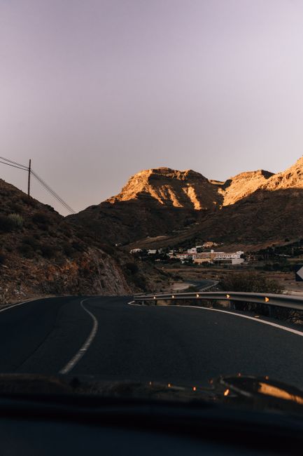 A serene mountain road with a sunset glow in Spain, perfect for road trips.