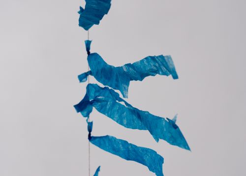 Free Close-up of blue streamers against a grey sky, capturing movement and whimsy. Stock Photo