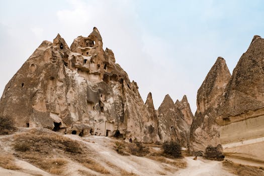 Stunning rock formations in Cappadocia with ancient caves and unique geology, Nevşehir, Turkey.