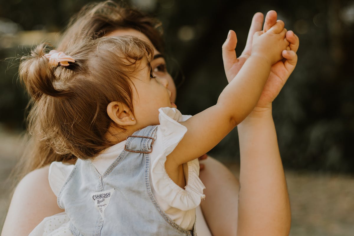 Mother and Little Daughter Holding Hands