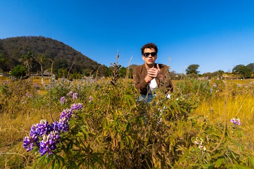 Free stock photo of blue sky, brown grass, brown jacket