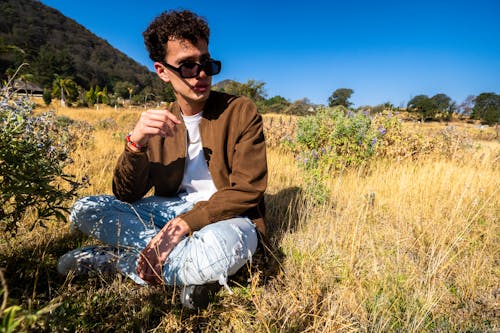 Free stock photo of blue sky, brown grass, brown jacket