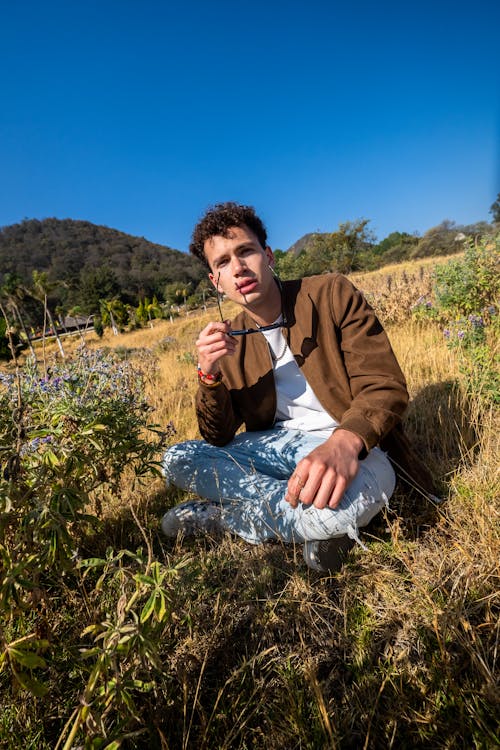 Free stock photo of blue sky, brown grass, brown jacket