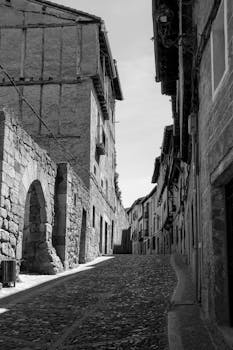 Black and white photo of a historic alley in Frías, Spain.