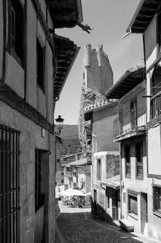 Explore the medieval streets of Frías, Spain, featuring iconic stone tower.
