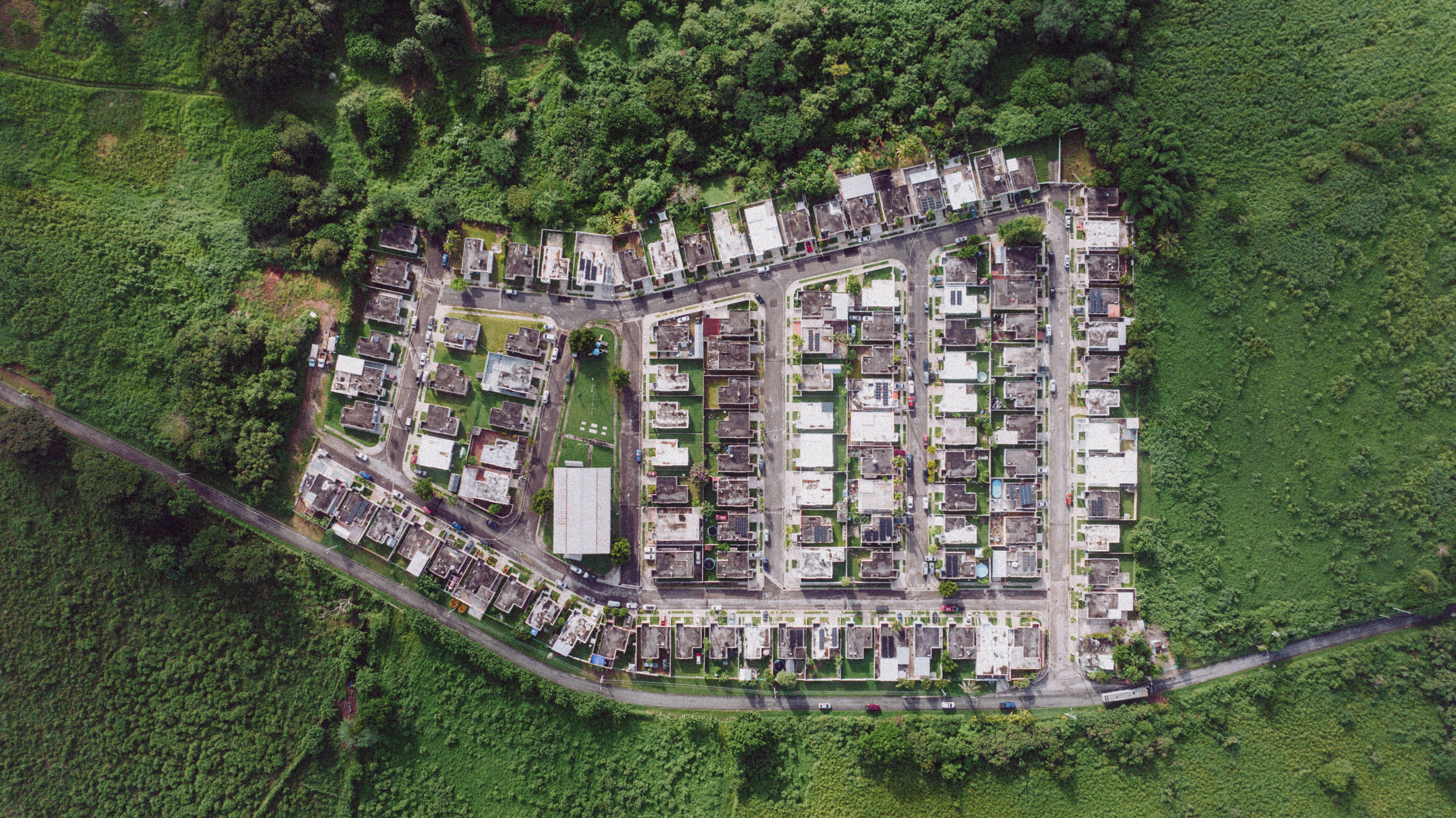 Aerial shot of a village surrounded by lush greenery in Patillas, Puerto Rico.