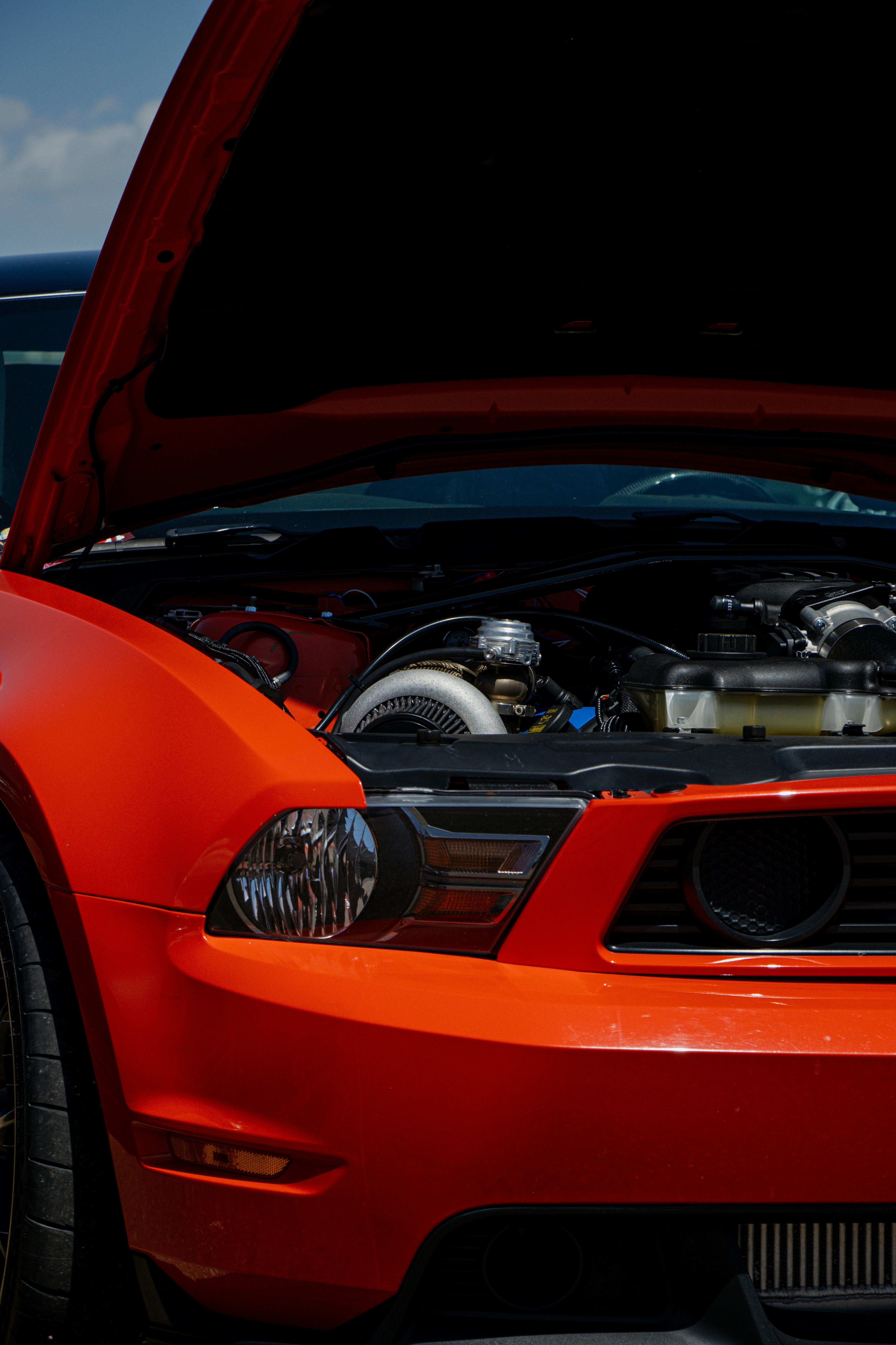 engine parts of a red ford mustang boss