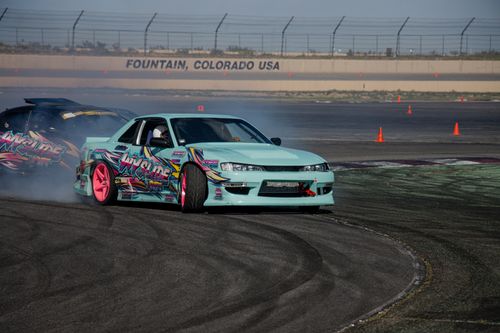 Free High-performance sports cars drifting during an event at a Colorado track, showcasing vibrant designs and skills. Stock Photo