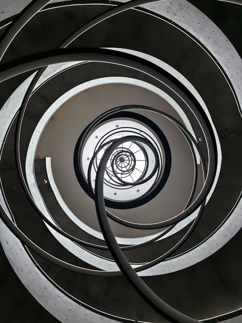 A spiral staircase with black and white lines