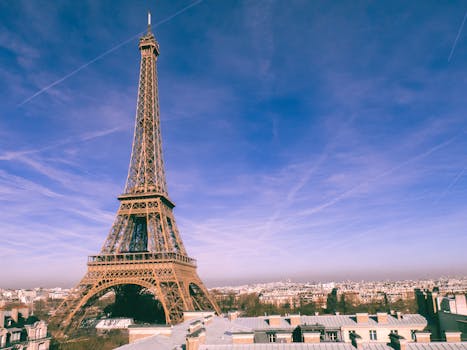 A stunning view of the Eiffel Tower under a bright blue sky in Paris, France.