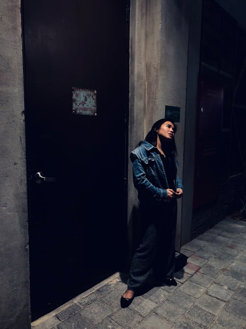 Free Woman Standing Beside Door Stock Photo
