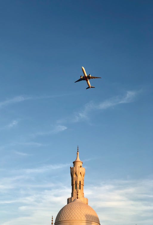 Free Airplane Flying Above Building Stock Photo