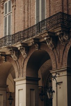 A close-up view of elegant vintage architecture featuring arches and ornate balconies.
