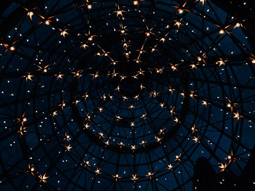 Free From below of glass round dome of house with sparkling lights against dark sky Stock Photo
