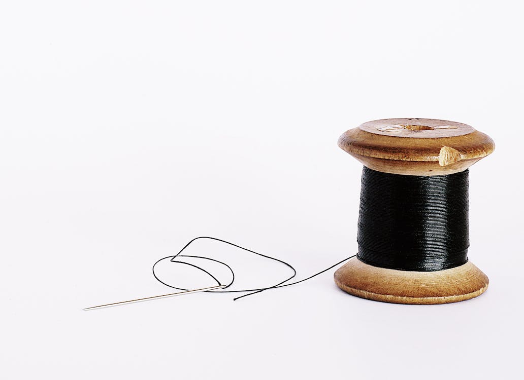 Sewing Needle With Black Thread Stuck In Wooden Spool With Black Threads  Close Up Isolated On White Background Stock Photo - Download Image Now -  iStock