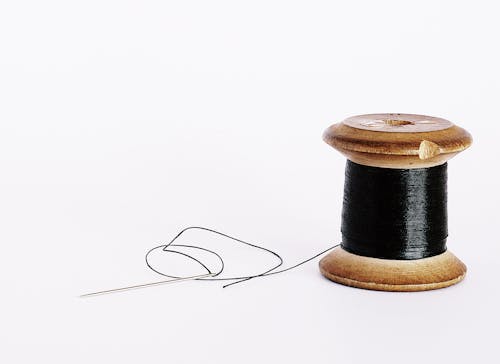 Free Black Thread On A Wooden Spool Stock Photo