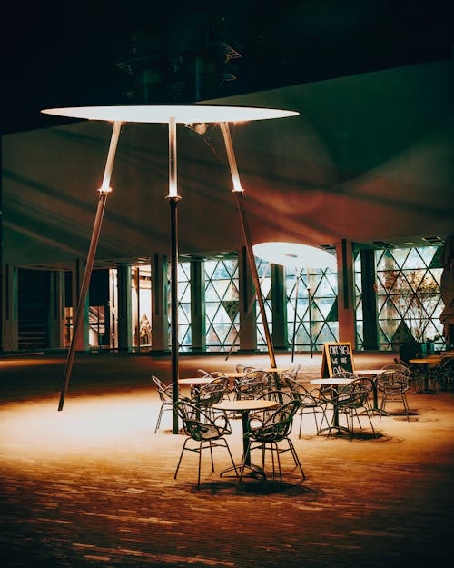 A large table and chairs in a dark room