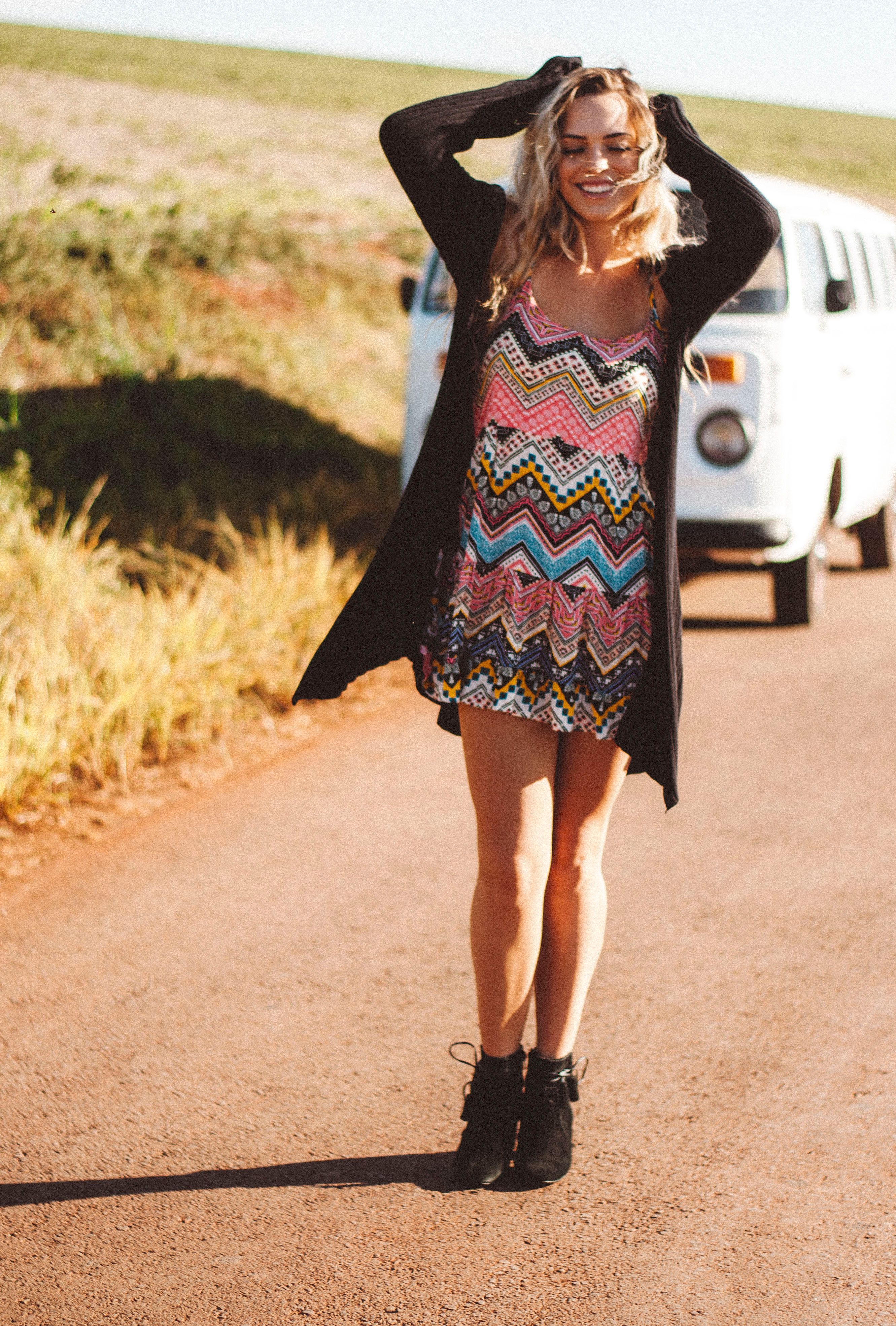 A Young Woman in a Dress Standing next to a Vintage Car · Free Stock Photo