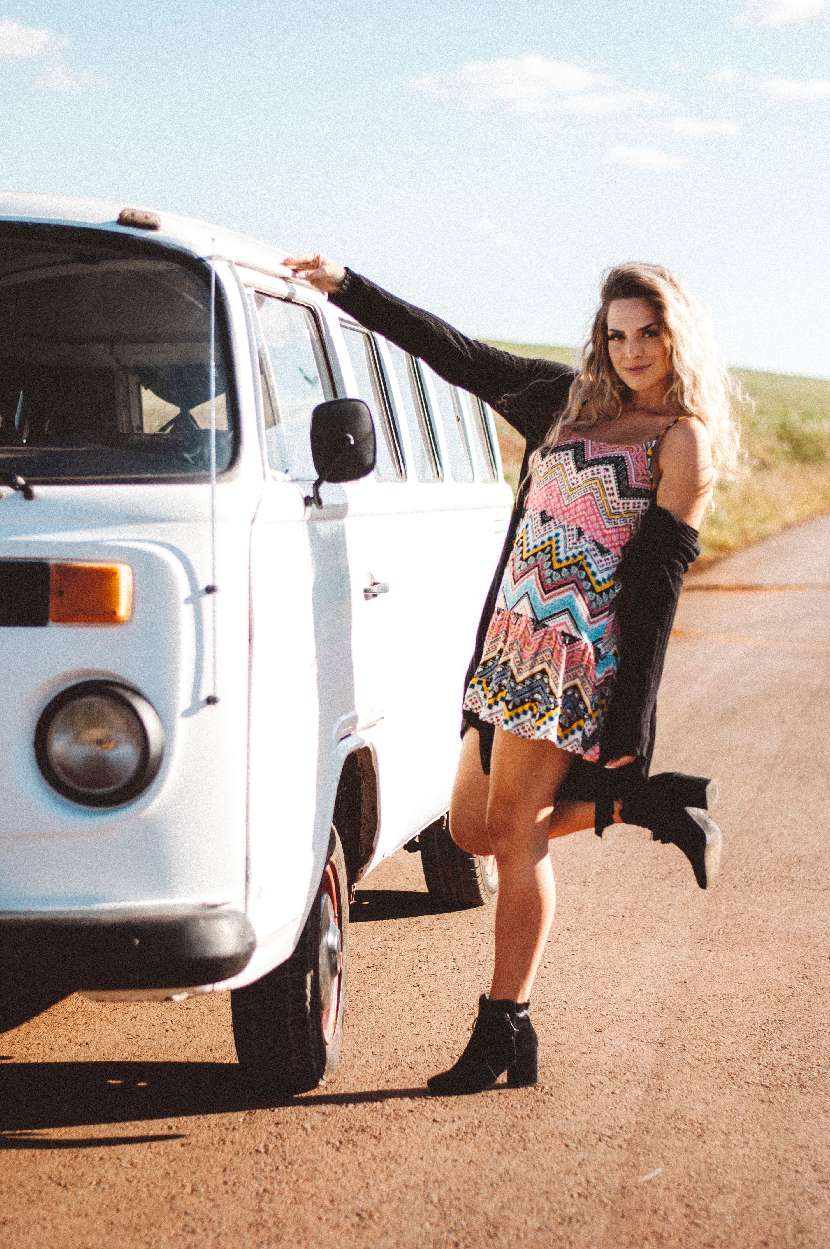 A Young Woman in a Dress Standing next to a Vintage Car · Free Stock Photo