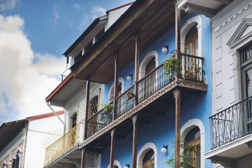 Free Low angle view of a historic blue urban building with detailed balconies and arched windows in daylight. Stock Photo