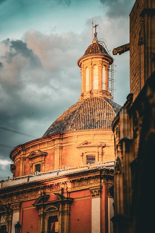 A church with a dome and a cloudy sky