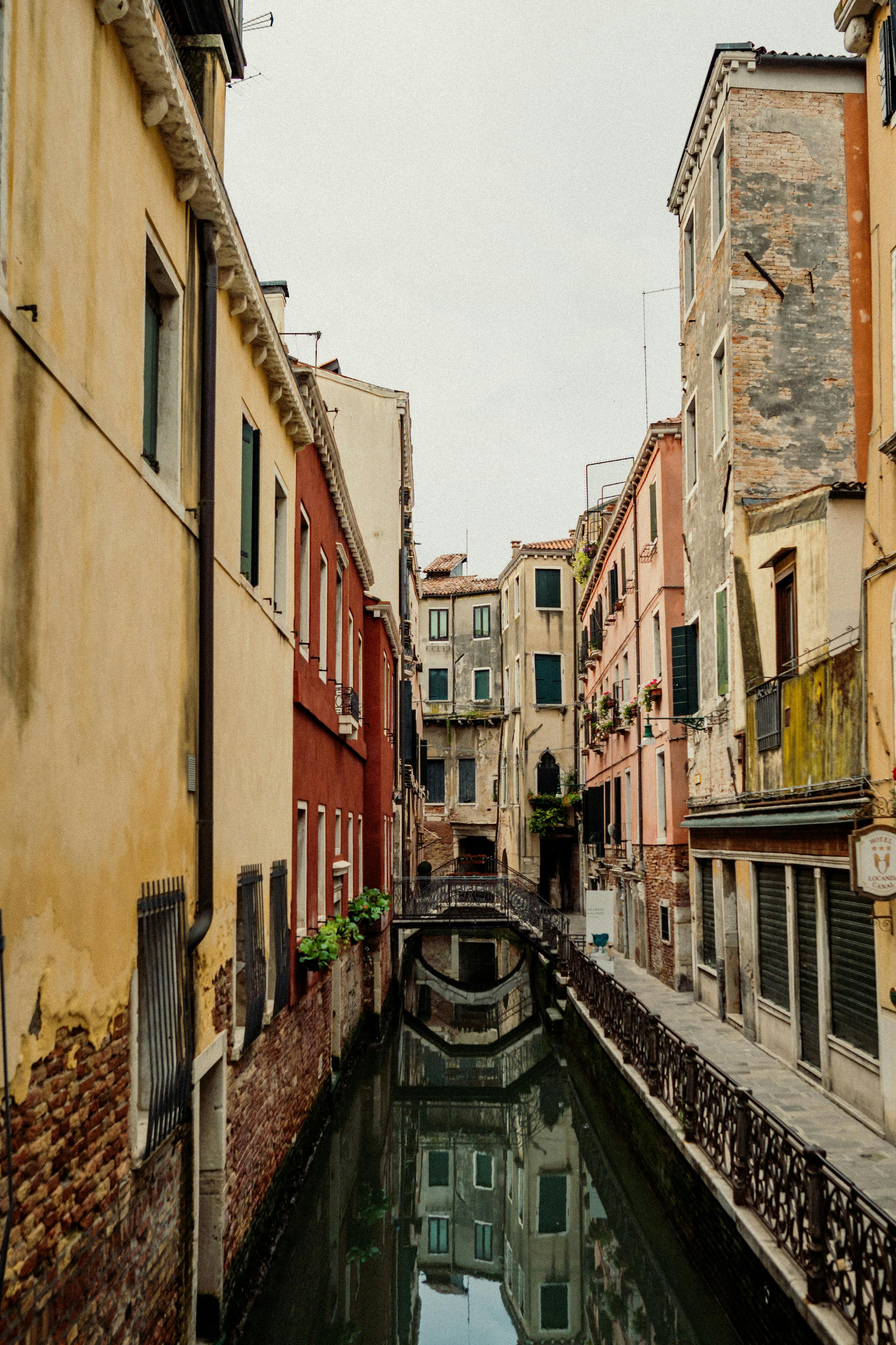 Picturesque view of a quiet canal in Venice with traditional architecture lining the sides.